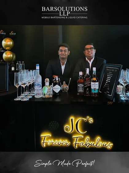 Our bartenders at a sleek, modern bar setup for a private birthday celebration, complete with custom neon signage.