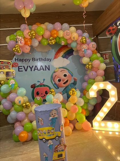 A Cocomelon ring setup for Evyaan's 2nd birthday, with a custom backdrop, marquee number, and themed pillar.