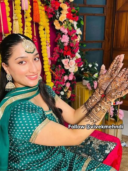 A beautiful client at her engagement ceremony. Her mehndi is detailed yet elegant, perfectly complementing her traditional attire.