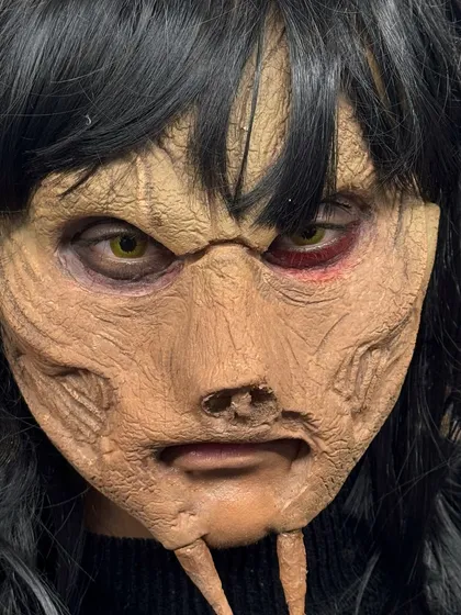 A terrifying close-up of the finished creature's face, showcasing the detailed sculpting and paint job.