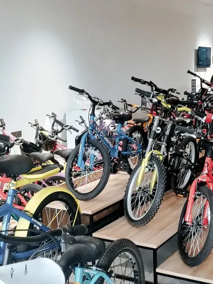This tiered display system maximizes the number of bicycles shown in a compact footprint. The use of natural wood adds a warm, organic element to the modern retail interior.