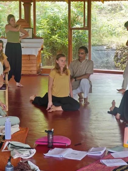 Our workshops provide a space for interactive learning. Students gather around a teacher to observe a demonstration, asking questions and gaining a practical understanding of complex asanas and adjustments.