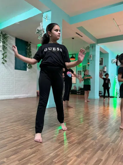 A student in our intermediate class holding her pose with confidence and attitude. We teach our dancers to own their space.