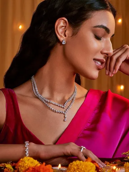 A festive look perfect for Diwali or a wedding event. The makeup is warm and glowing, with a soft shimmer on the eyes and a berry lip that complements the rich pink saree.