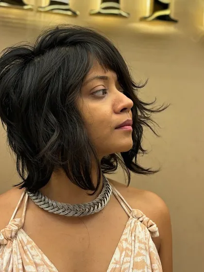 A side view of a textured short haircut, showing how the layers are cut to create volume and a stylish, windswept effect.