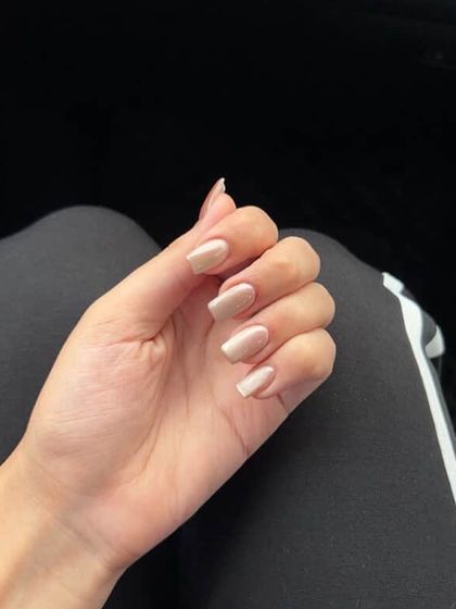 A simple and chic nude cat eye manicure on short, square nails.