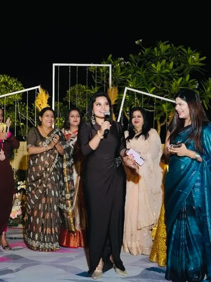 Interacting with a group of ladies at an outdoor evening event. Their smiles and applause are my motivation.