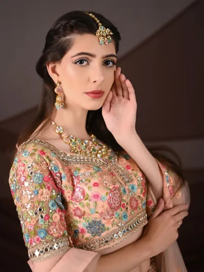Another close-up highlighting the beautiful embroidery on the blouse of the peach floral lehenga. It's a work of art.