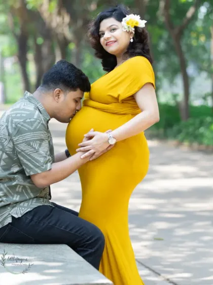 A tender moment during a maternity shoot, with an expecting father kissing his wife's belly. I love capturing this quiet connection in the soft, golden hour light of a park.