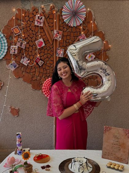 Posing proudly with the '5' balloon, this photo is a thank you to everyone who has been a part of The Artsy Co. family.