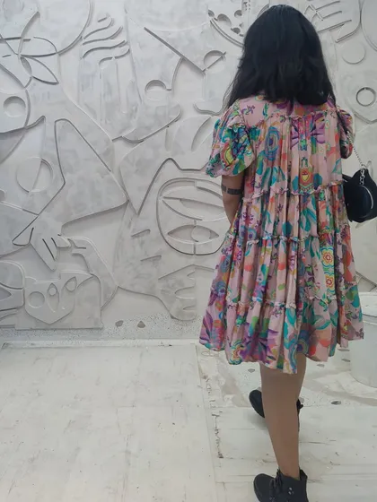 To show the monumental scale of our work, this image captures a person standing beside a large, abstract 3D wall mural. Made from plaster, the piece is a 'cosmic tapestry' of layered shapes and lines, transforming a simple wall into a landscape of myth and memory.