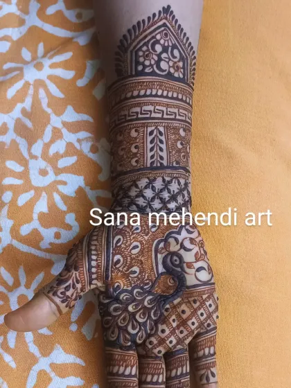 A single hand showcasing a detailed peacock design. The intricate feather work and the surrounding patterns are a testament to fine craftsmanship.