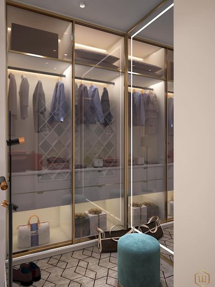 A walk-in closet concept with glass doors and integrated lighting. The design includes a mix of hanging space and drawers, with a small pouf for seating.