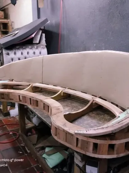 This is the skeleton of a custom curved sofa. I build every frame from solid wood to ensure it is strong and durable, creating the foundation for a piece that will last for many years.