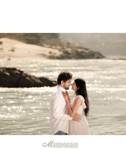 A tender pre-wedding portrait on the banks of the Ganga, with the sparkling water creating a beautiful, natural backdrop. The soft light and close embrace make this a truly romantic shot.