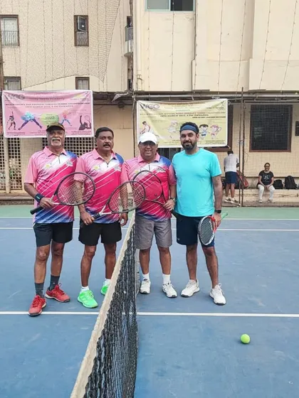 A pre-match photo of a Men's Doubles team at the net, ready for action.