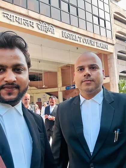 With a colleague at the Rohini District Court. Collaboration with other legal minds is often key to a successful outcome.