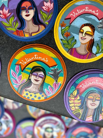 A close-up of the custom mini plates, each featuring a unique portrait and the squadron's name, 'Valiantinas'.
