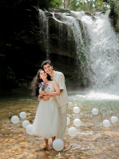 Another beautiful portrait, showcasing their connection and the grandeur of the waterfall behind them.