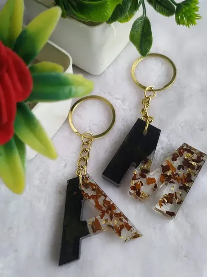 Matching keychains are a wonderful gift for couples or best friends. Here, I've created a set of initial keychains, preserving flower petals within a split black and clear design for a modern and personal touch.