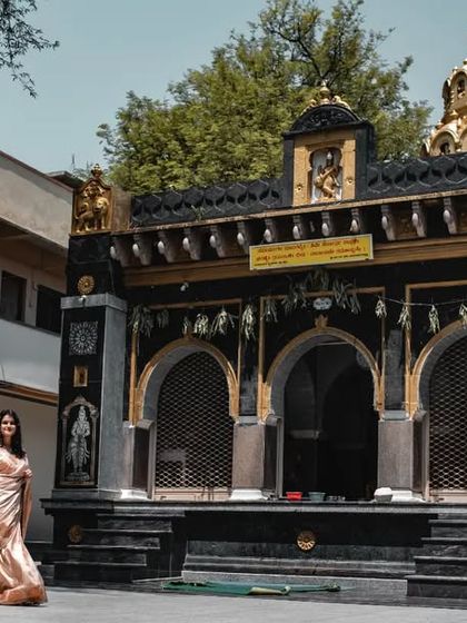 A grand, wide-angle shot of a couple in front of a traditional temple, blending romance with cultural architecture for a unique pre-wedding photo.