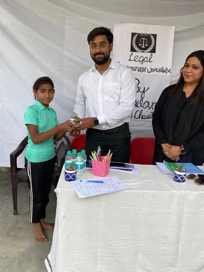 A young girl presents a small plant as a token of appreciation at our workshop. Moments like these reinforce the importance of our work in nurturing a safer future for the next generation.