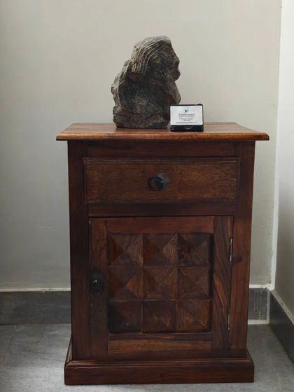 "The Timeless Beauty" abstract sculpture displayed on a wooden side table. Its compact size and intriguing form make it an exclusive decor piece for hotels or living rooms.