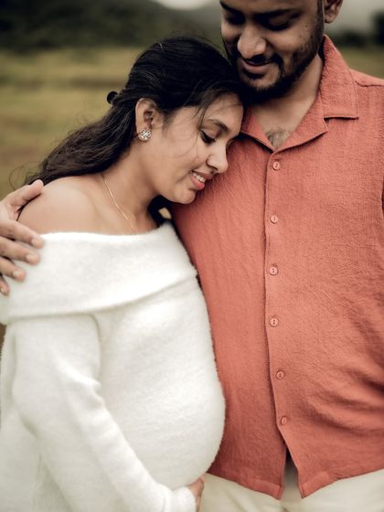 A close-up portrait filled with warmth and tenderness. She leans her head on his chest as he embraces her, a perfect picture of comfort and love.
