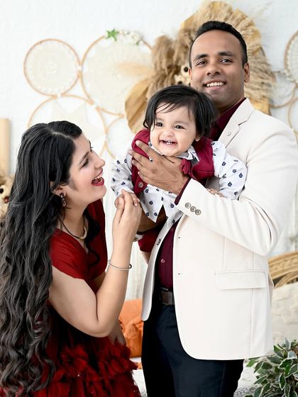 A candid moment of laughter between parents and their baby boy. These unposed shots are often the most cherished memories from a family session.