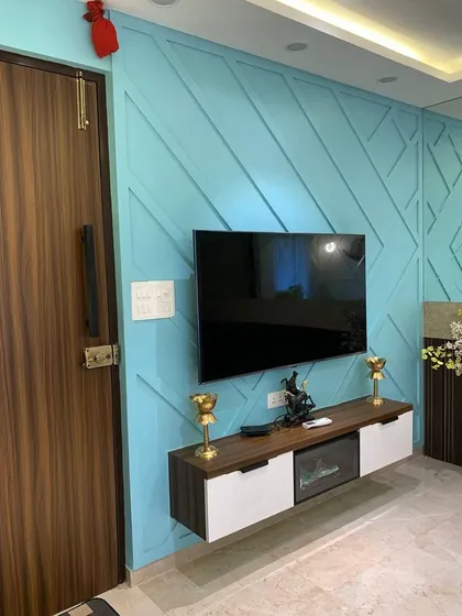 We used a bold turquoise color for this TV wall paneling to create a vibrant and energetic focal point. The floating console provides storage while maintaining a light, modern feel.