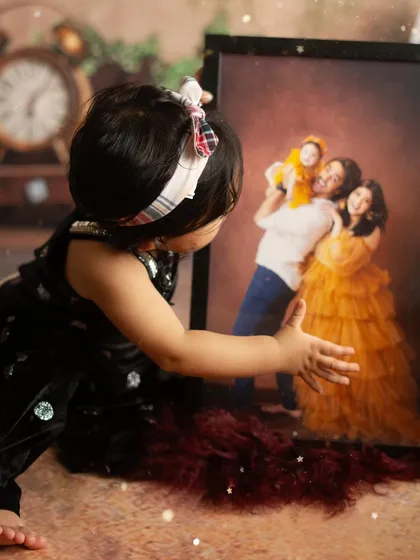 This is why I do what I do. A little girl looking at a portrait from her own family's session, a beautiful reminder that these photos become a part of your child's story.