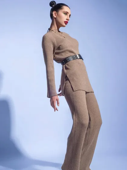 The same knit co-ord set, this time in a pose that emphasizes its clean lines and modern silhouette. It’s a versatile outfit that can be dressed up or down.