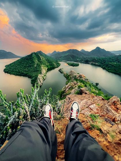 The view from Bahubali Hills in Udaipur, with my feet in the frame. This 'first-person' perspective makes the viewer feel like they are right there with me, taking in the sunset.