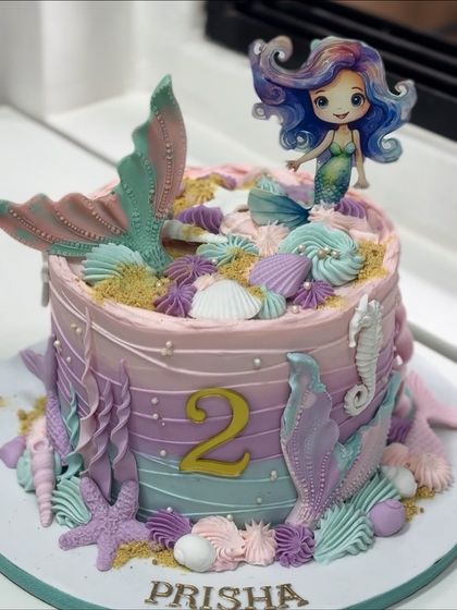 A splash of magic for a second birthday! This pastel mermaid cake brings an underwater fairytale to life with hand-piped swirls, fondant shells, and a beautiful mermaid tail.