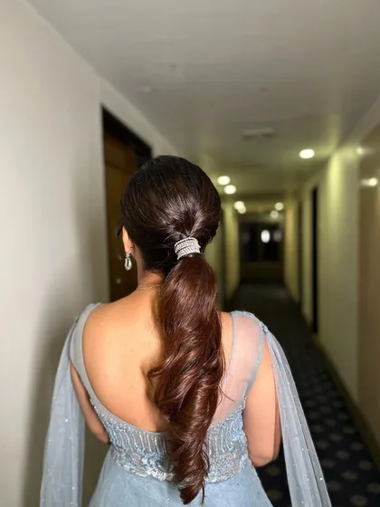 A detailed shot of the curled ponytail, showing the texture and shine.