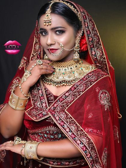 This shot captures the complete royal bride ensemble. The heavy jewellery, the rich velvet lehenga, and the confident pose all contribute to a look of regal elegance.