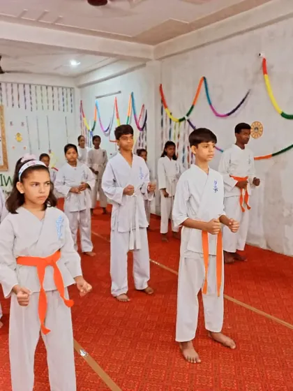 Students with orange belts demonstrating their readiness. They are focused and prepared.