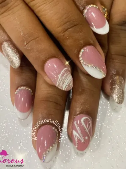 A sophisticated and glamorous set. We combined a soft pink base with a white French tip, and added a sparkling silver glitter ombré and delicate rhinestone details for a truly elegant finish.