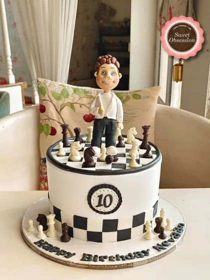 A clever chess-themed cake with a full edible chessboard and pieces, topped with a personalized figure for a 10th birthday.