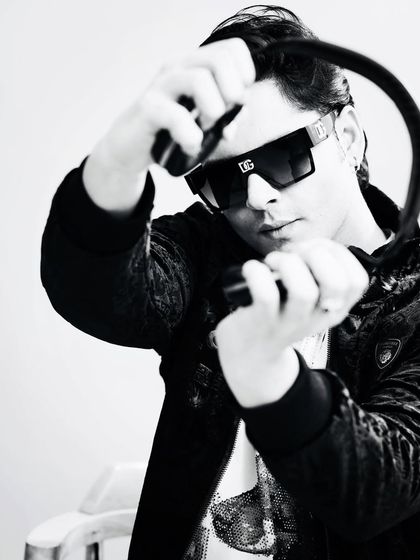 A black and white shot from a recent photoshoot. My headphones are my most important tool, connecting me to the music and the crowd.