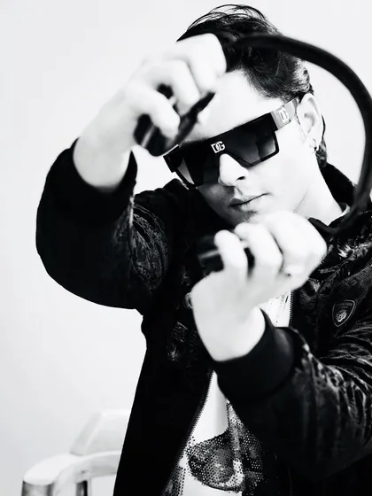 A black and white shot from a recent photoshoot. My headphones are my most important tool, connecting me to the music and the crowd.