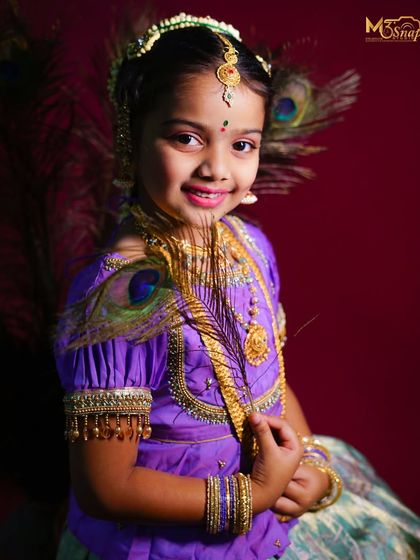 A classic and elegant portrait. Her gentle smile and the way she holds the peacock feather create a graceful and timeless image that celebrates tradition.