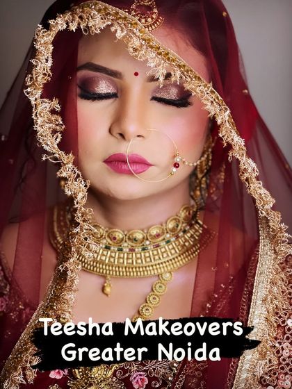 A gorgeous bride framed by her embroidered veil. The makeup is classic and elegant, with a focus on glowing skin.