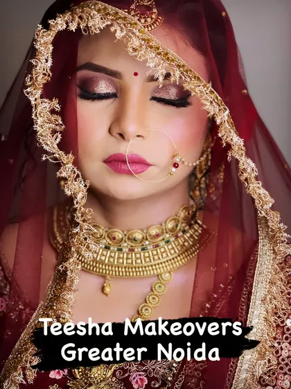 A gorgeous bride framed by her embroidered veil. The makeup is classic and elegant, with a focus on glowing skin.