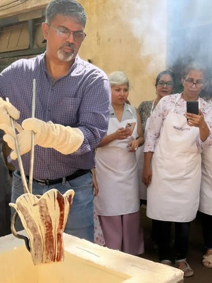 With tongs and protective gloves, I carefully lift a piece from the kiln. Students watch closely, learning about the safety and technique required for Raku.