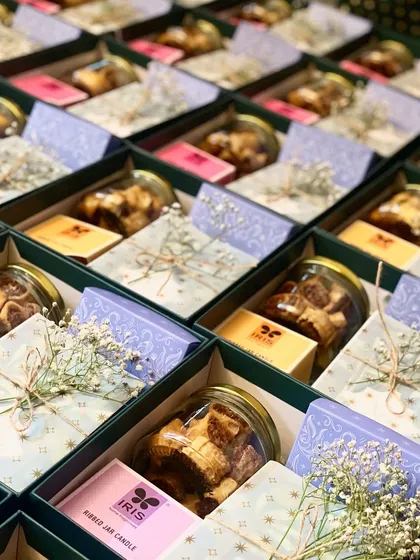A side view of the wedding invitation hampers, showcasing the depth of the gift box and the variety of items inside.