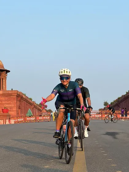 Waving to the camera while riding.