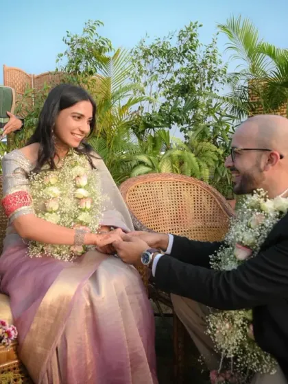 The moment he proposes during their outdoor engagement ceremony. The genuine surprise and joy on their faces, with family applauding in the background, makes this a priceless memory.