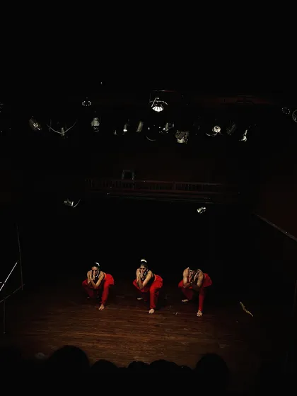 The stage is set for a powerful Kalaripayattu performance. The dramatic lighting enhances the intensity of this ancient martial art.