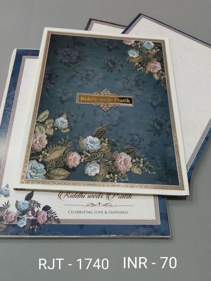 A beautiful floral invitation in a deep teal color. The design is rich and elegant, with matching inserts that continue the floral theme.